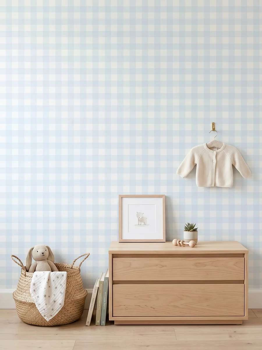 Anna, papel pintado vichy azul celeste y blanco, a escala pequeña en habitación infantil con cómoda, elementos decorativos y mobiliario de estilo natural.